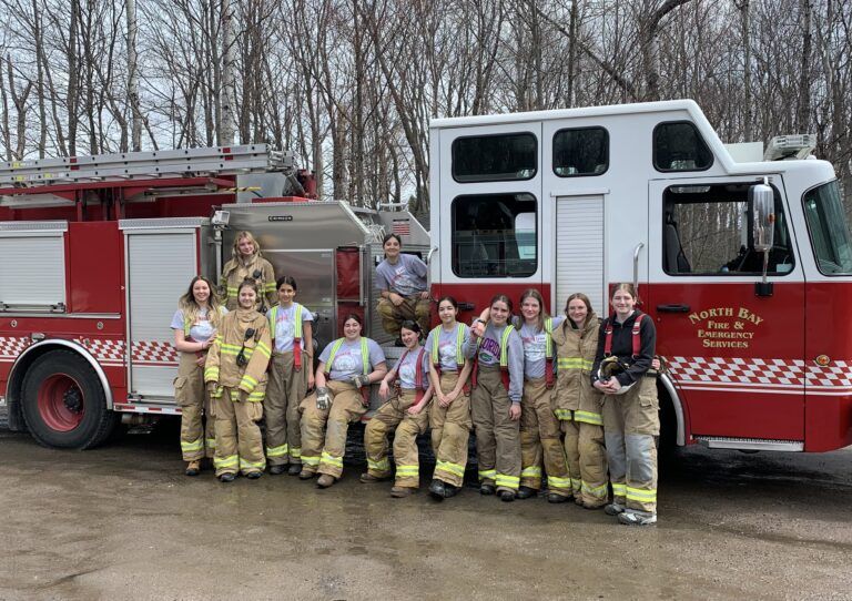 Female students learning more about a career in firefighting