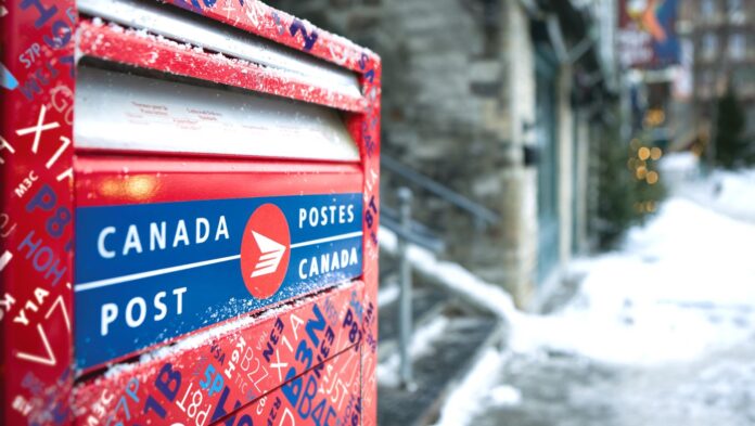 Close-up of a Canada Post mailbox highlighting its drop-off slot